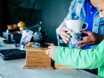 People holding coffee cup on table