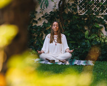 Portrait of young woman sitting outdoors