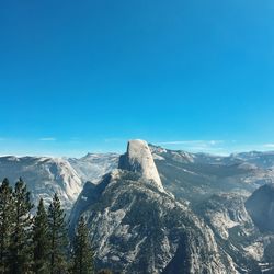 Scenic view of mountains against blue sky