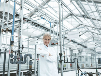 Scientist with arms crossed in industry