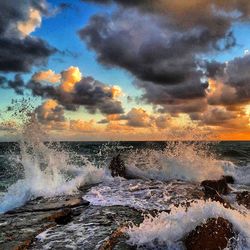 Scenic view of sea against cloudy sky