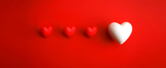 Close-up of heart shape against red background