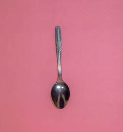 Close-up of metal against pink background