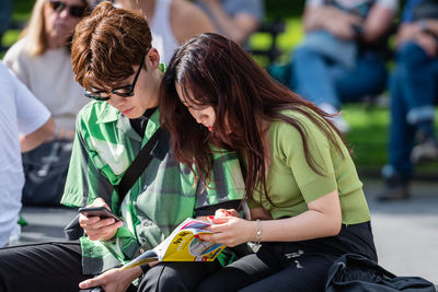 Woman sitting on mobile phone
