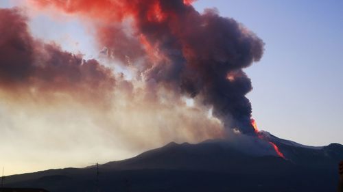 Smoke emitting from volcanic mountain against sky