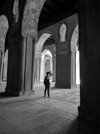 Rear view of man walking in historic building
