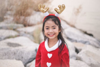 Portrait of smiling girl standing outdoors