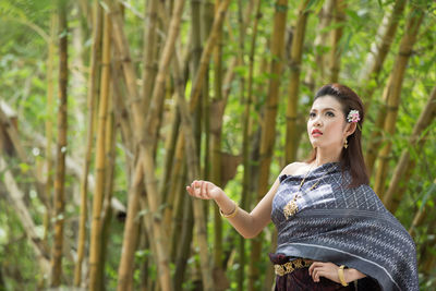 Young woman standing in a forest