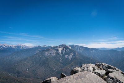 Scenic view of mountains against blue sky