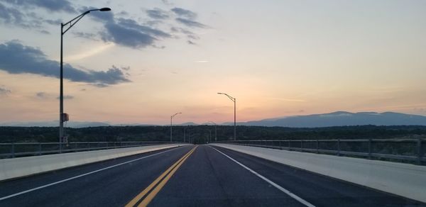 View of highway against sky during sunset