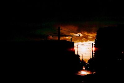 View of illuminated street lights at night