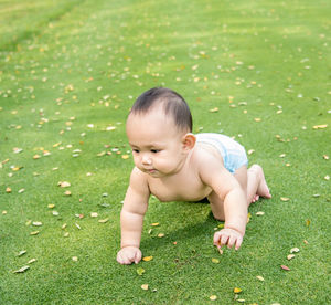 Full length of cute baby girl playing on field at public park