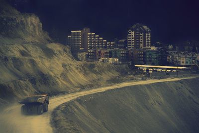 High angle view of vehicles on road along buildings