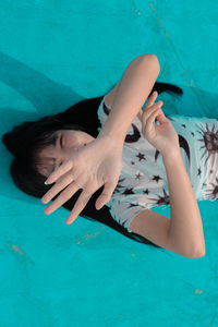 High angle view of woman lying on swimming pool