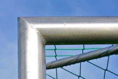 Low angle view of metal pole against blue sky