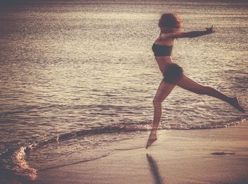 Full length of woman standing on beach