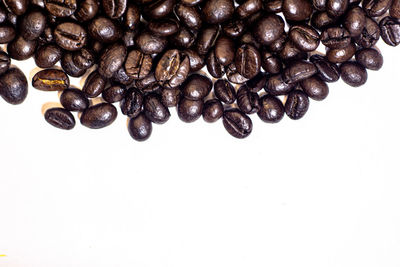 High angle view of coffee beans against white background