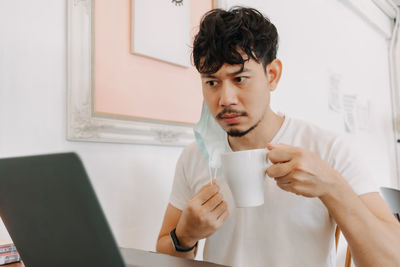 Young woman drinking coffee cup