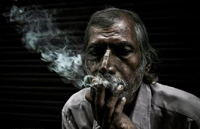 Portrait of man smoking cigarette