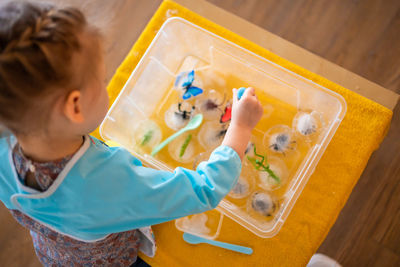High angle view of boy playing with toys on table