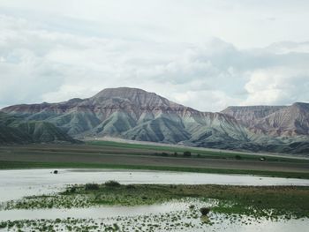 Scenic view of lake and mountains against sky