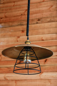 Close-up of illuminated electric lamp on table