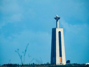 Low angle view of statue against blue sky