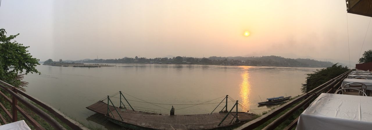 water, sky, nautical vessel, scenics, tranquility, tranquil scene, beauty in nature, sun, transportation, nature, sunset, reflection, lake, mode of transport, boat, moored, sea, panoramic, sunlight, idyllic