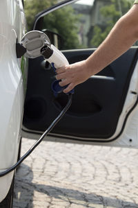 Cropped hand refueling car