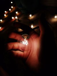 Close-up of hand holding illuminated lights