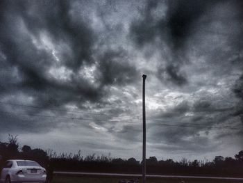 Low angle view of road against cloudy sky