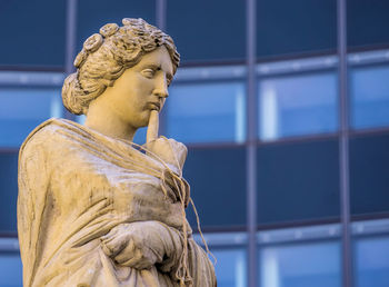 Low angle view of statue against built structure