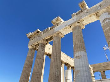 Low angle view of acropolis against clear blue sky.