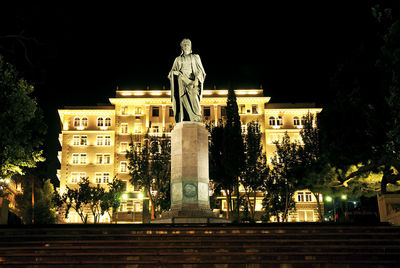 Low angle view of statue against sky at night