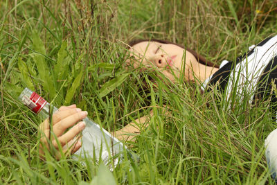 Woman lying on grass in field