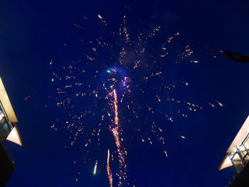 Low angle view of firework display against sky at night