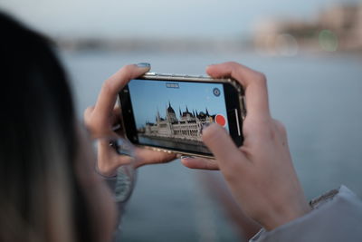 Midsection of woman using mobile phone