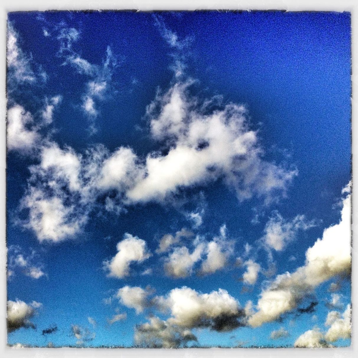 transfer print, blue, low angle view, auto post production filter, sky, cloud - sky, beauty in nature, cloud, nature, tranquility, scenics, cloudy, day, outdoors, sky only, backgrounds, tranquil scene, no people, white color, sunlight