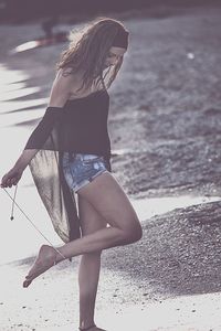 Woman with umbrella on beach