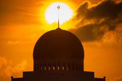 Low angle view of silhouette building against sky during sunset