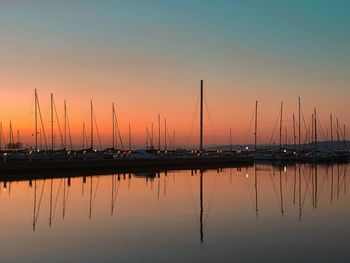 Sailboats in marina at sunset