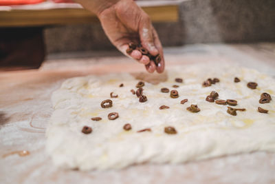 Midsection of person preparing meat on table