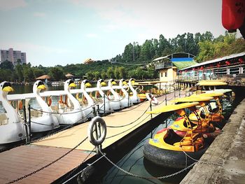 Scenic view of boats moored in river against sky