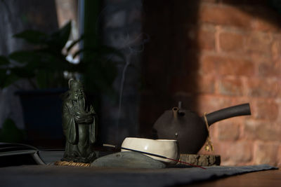 Close-up of electric lamp on table at home