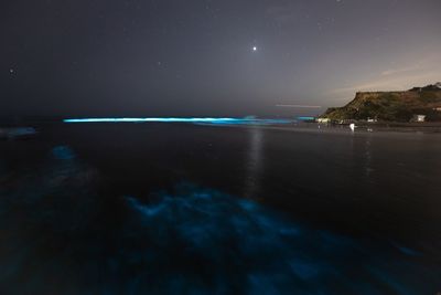 Scenic view of sea against sky at night