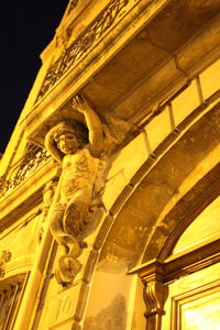 Low angle view of statue against building