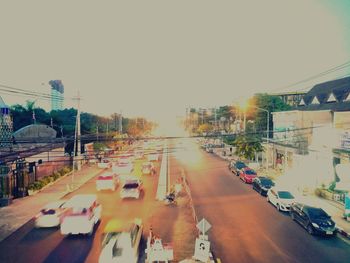 Traffic on road in city against clear sky