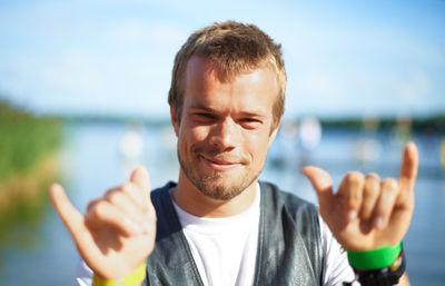 Portrait of young man against sky