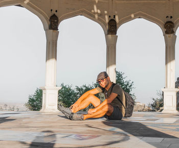 Portrait of man wearing sunglasses while siting in gazebo