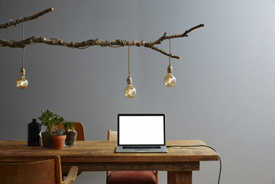 Illuminated electric lamp hanging on table